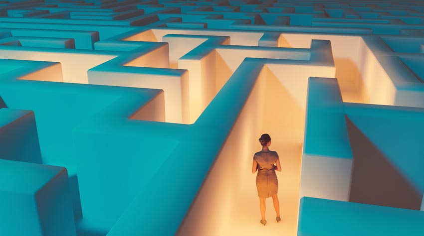 Illustration of woman looking back to view path taken in maze