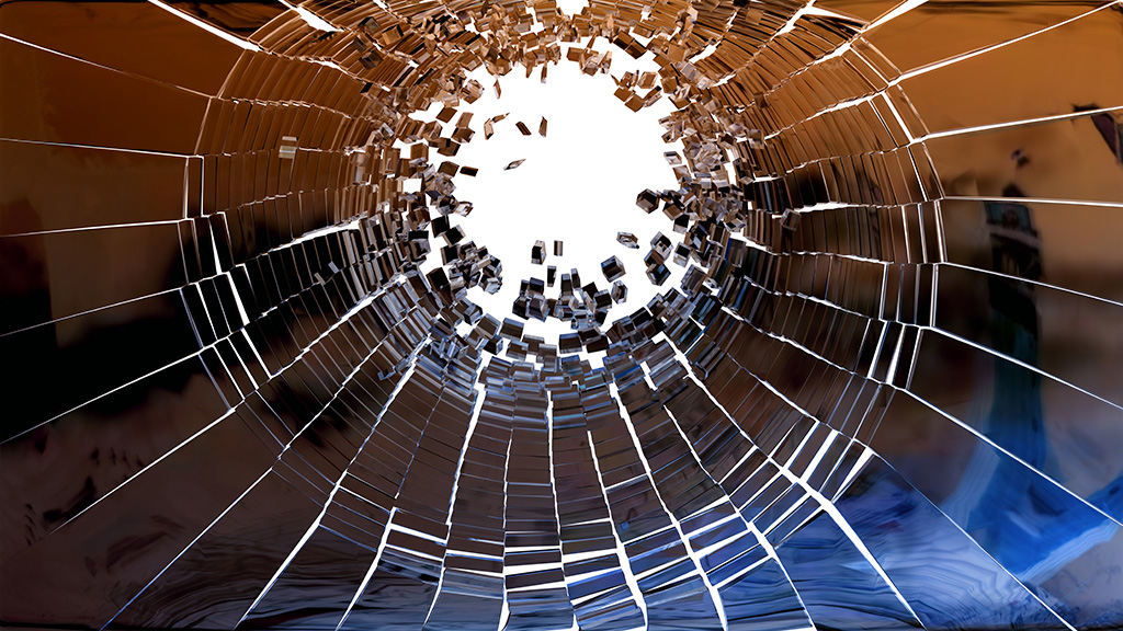 Photograph of fragments of broken mirror in a circular arrangement indicative of an exploding silo.